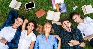 Image Shows College Students Laying On Grass With Books