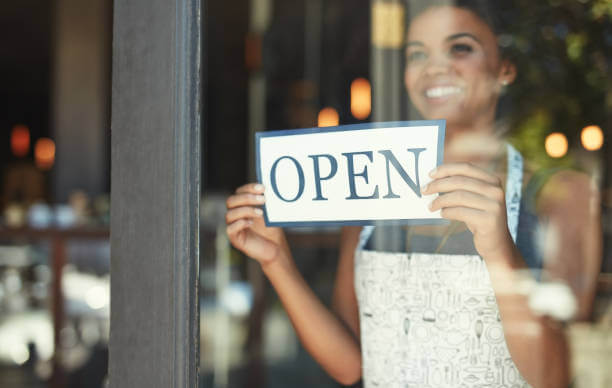 Image Shows Woman Opening Her Small Business