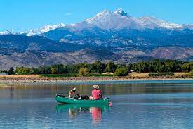 Image Shows Couple On A Boat In The Water With Mountain Views Of Longmont, Co